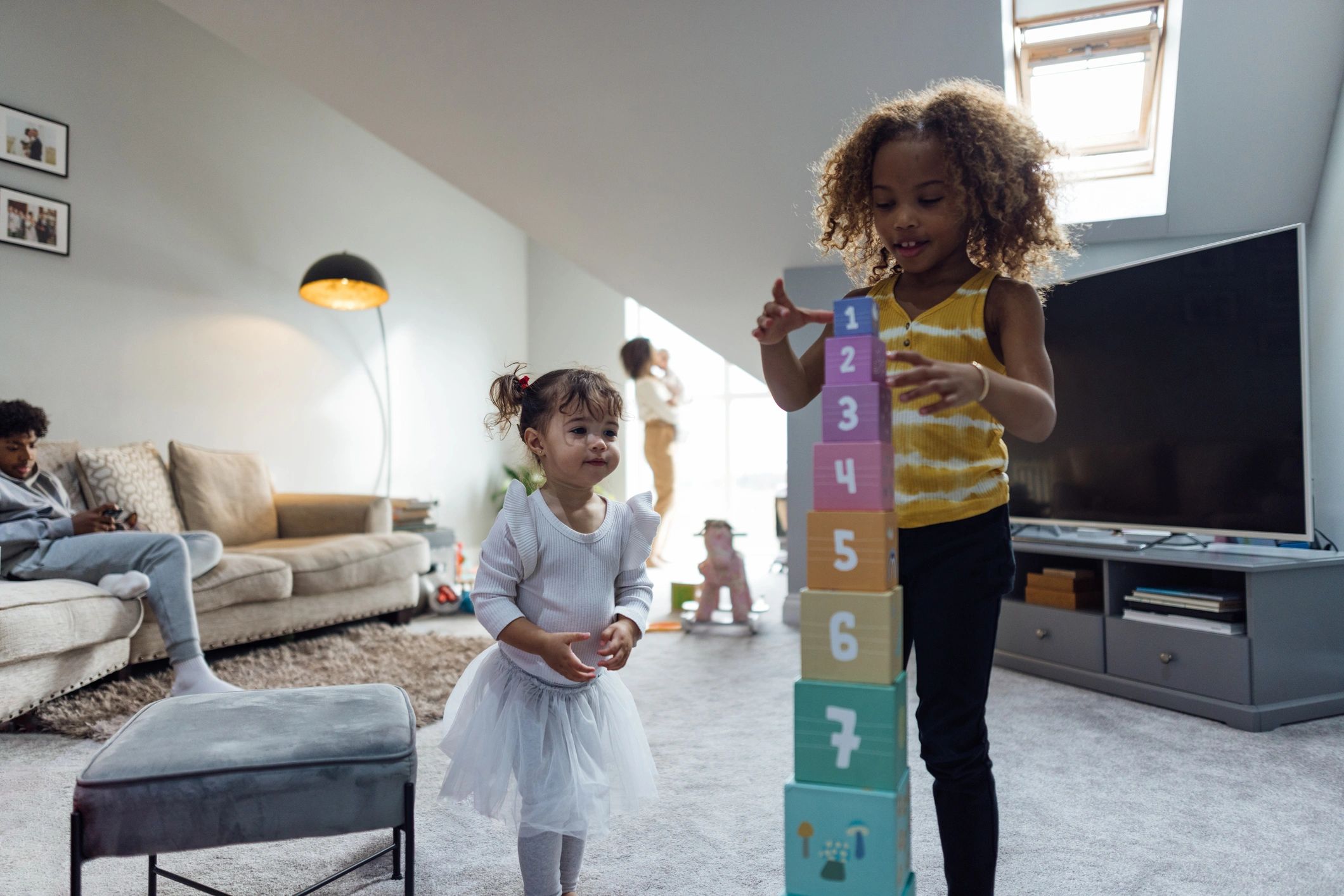 Young girl building a tower of toy blocks